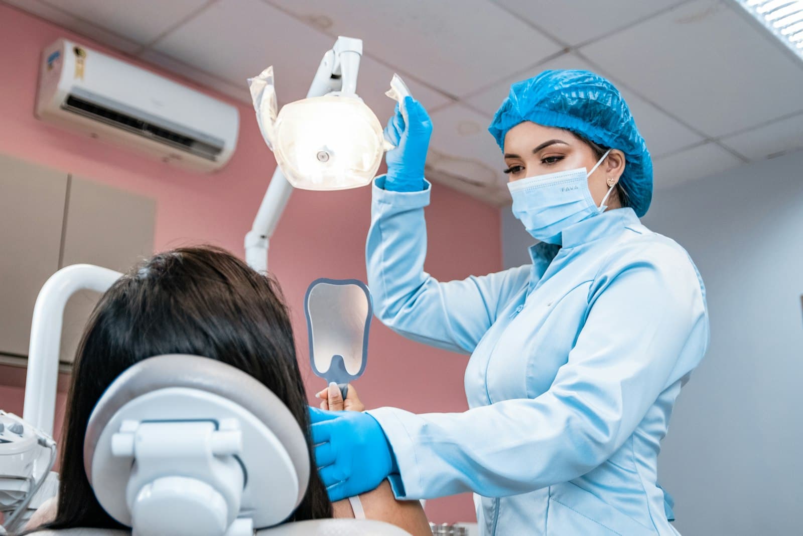 A dentist checking a patient's teeth