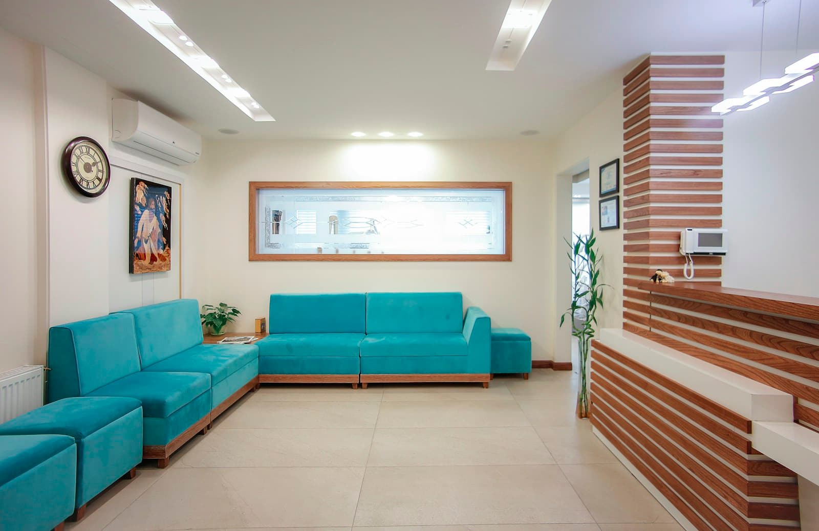 A calm clinic waiting room with a blue sofa and plants
